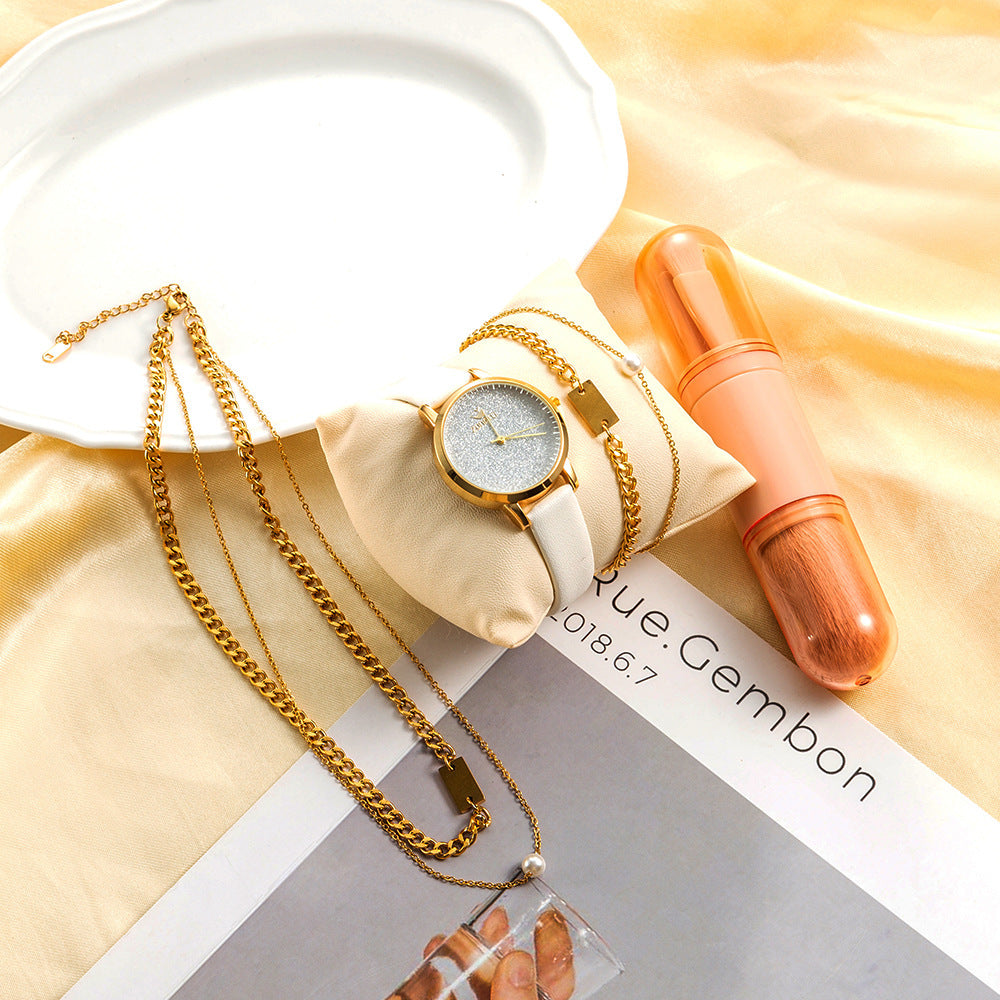 Detta fyrdelade presentset för damer kombinerar en stilren quartzklocka med matchande smycken och en makeupborste, vilket gör det till en komplett och elegant gåvobox.